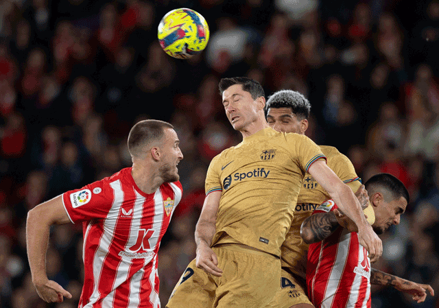 Barcelona’s Robert Lewandowski (2nd-left) fights for the ball with Almeria’s Rodrigo Ely (left) and Chumi (right) during their Spanish League match in Almeria on Sunday (AFP photo by JORGE Guerrero)