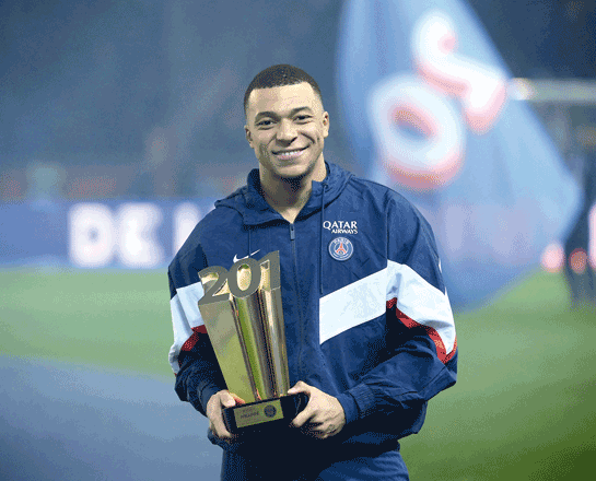 French forward Kylian Mbappe poses with a trophy at the end of a ceremony after he became Paris Saint-Germain’s all-time top scorer with his 201st goal for the club in Paris on Saturday (AFP photo by Franck Fife)