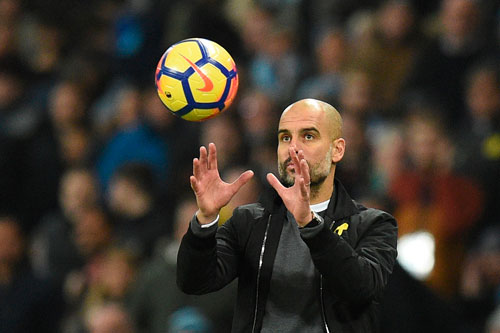 Manchester City’s Spanish manager Pep Guardiola catches the ball on the touchline during the English Premier League football match against Bournemouth in Manchester, England, on Saturday  (AFP photo by Oli Scarff)