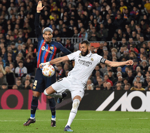 Real Madrid’s forward Karim Benzema kicks the ball and scores his team’s fourth goal against Barcelona during their Copa del Rey semifinal second leg match in Barcelona on Wednesday (AFP photo by Pau Barrena)