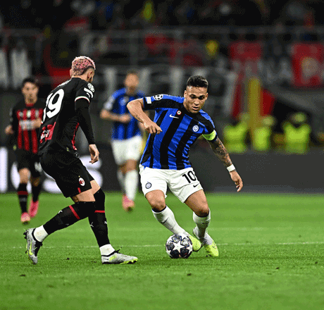 Inter Milan’s forward Lautaro Martinez (right) challenges AC Milan’s defender Theo Hernandez during their UEFA Champions League semifinal first leg match in Milan on Wednesday (AFP photo by Gabriel Bouys)