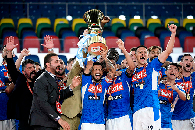 Napoli's Italian forward Lorenzo Insigne holds the trophy, Napoli's Italian head coach Gennaro Gattuso (left) and players celebrate after winning the Italian Cup final against Juventus in Rome on Wednesday (AFP photo by Filippo Monteforte)