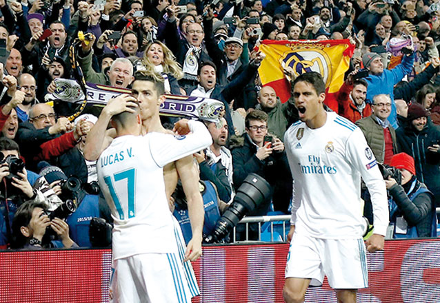 Real Madrid’s Portuguese forward Cristiano Ronaldo (2nd left) celebrates with Real Madrid’s Spanish midfielder Lucas Vazquez and Real Madrid’s French defender Raphael Varane after scoring during the UEFA Champions League quarter-final second leg match between Real Madrid CF and Juventus FC in Madrid on Wednesday (AFP photo)