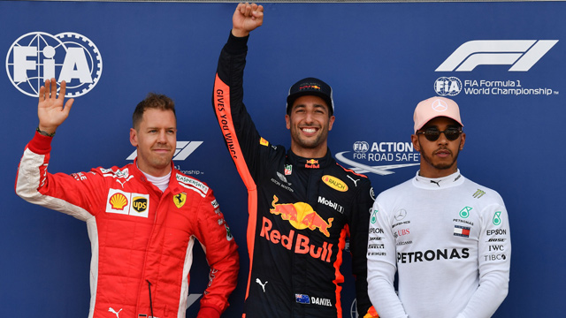 First placed Red Bull Racing’s Australian driver Daniel Ricciardo (centre) celebrates winning the pole position next to second placed Ferrari’s German driver Sebastian Vettel (left) and third placed Mercedes’ British driver Lewis Hamilton after the qualifying session at the Monaco street circuit on Saturday in Monaco, ahead of the Monaco Formula 1 Grand Prix (AFP photo)