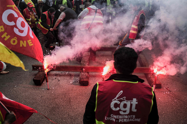 Striking employees of the French state-owned rail operator SNCF install rails in front of the MEDEF’s (French employers’ association) branch in Lyon, on Wednesday (AFP photo)
