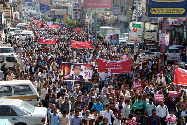 Demonstrators chant slogans as they march with banners during a rally protesting the comments of French President Emmanuel Macron over Prophet Mohammad cartoons, in Yemen's third city of Taez, on Saturday (AFP photo)