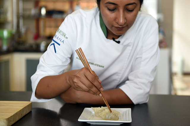 This photo taken on December 20, 2019 shows Karana chef-in-residence Sowmiya Venkatesan making plant-based dumplings from jackfruit in Singapore (AFP photo by Catherine Lai)