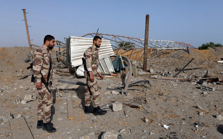 Members of Palestinian security forces loyal to Hamas survey a Hamas site after it was hit by an Israeli air strike in Rafah in the southern Gaza Strip on Wednesdasy (Reuters photo)