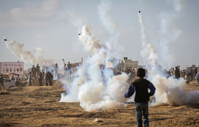 Israeli occupation forces intervene to Palestinian demonstrators with tear gas during a protest organised to mark 70th anniversary of Nakba, also known as the catastrophe in 1948, and against US decision to relocate the US embassy from Tel Aviv to Jerusalem, at Gaza-Israel border in eastern part of Shujaiyya Neighbourhood of Gaza City, Gaza, on Tuesday (Anadolu Agency photo)