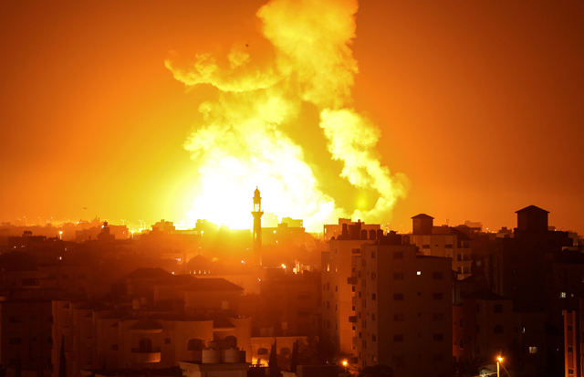 Fires are seen following an Israeli air strike in Gaza City on Saturday. Israeli warplanes struck a weapons manufacturing facility in the Gaza Strip, the occupation army said, after reported rocket fire against Israeli territory (AFP photo)