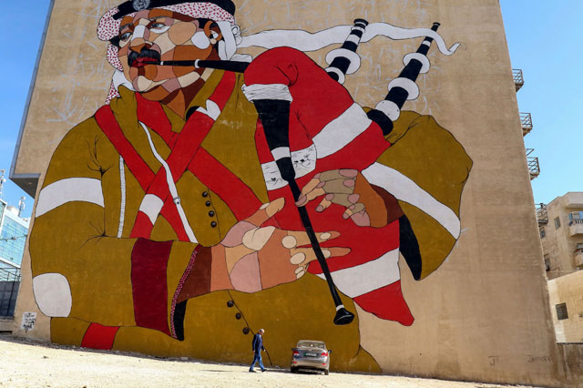 Top: A picture taken on December 17 shows a graffiti mural on a wall in Amman (AFP photo by Khalil Mazraawi)