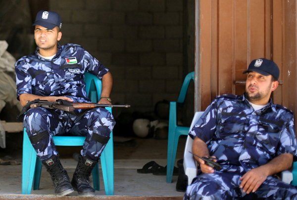 Palestinian policemen loyal to Hamas keep guard in Khan Younis in the southern Gaza Strip, on Tuesday (Reuters photo)