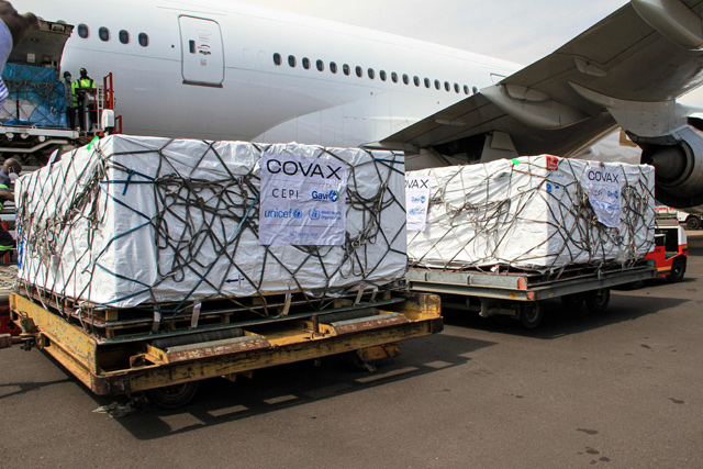 Employees unload boxes of Oxford/AstraZeneca vaccines against the COVID-19 from a plane after their delivery as a part of the UN-led Covax initiative, which assists poorer countries to receive the medicine, at Entebbe international airport, on Thursday (AFP photo)