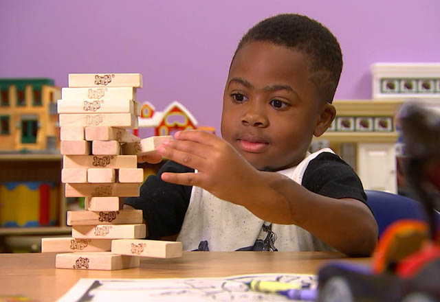 10-year-old Zion Harvey plays Jenga on Monday after undergoing a double hand transplant in July 2015 (AFP photo)