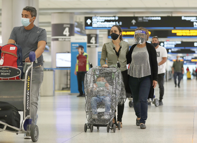 Travellers walk through Miami International Airport on Monday in Miami, Florida (AFP photo)