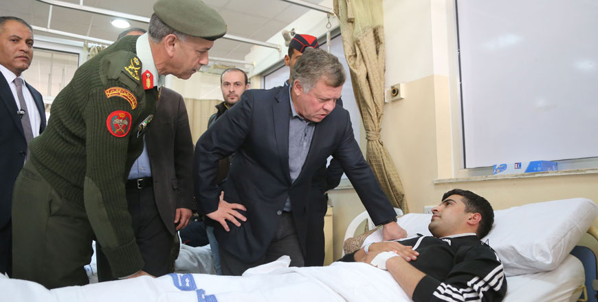  His Majesty King Abdullah checks on a man injured in the Karak terror attack during a visit to the King Hussein Medical City on Monday (Photo courtesy of Royal Court)