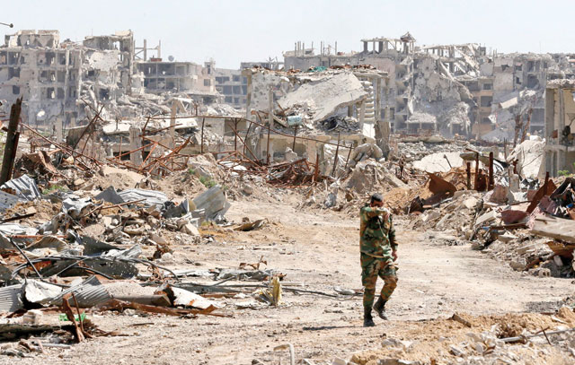 A Syrian regime soldier walks amid the destruction in Jobar in Eastern Ghouta, on the outskirts of the capital Damascus, on Monday (AFP photo)