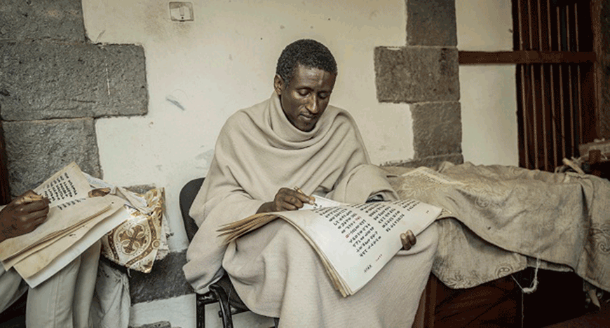 Zelalem Mola, 42, an Ethiopian Orthodox priest and a member of Hamere Berhan initiative writes scriptures in Ge’ez language on parchment made of goatskin in Addis Ababa, Ethiopia, on May 17 (AFP photo by Amanuel Sileshi)