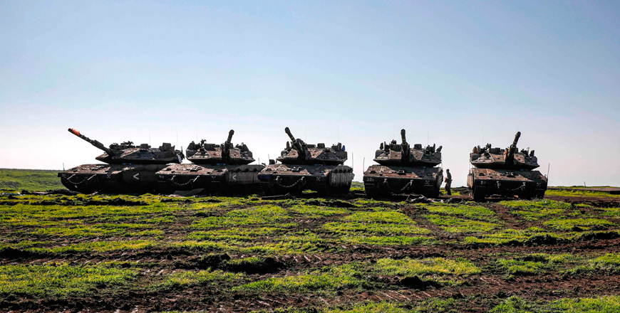 Israeli tanks hold position near Moshav Kidmat Tzvi in the occupied Golan Heights on Friday (AFP photo)