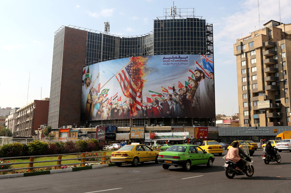 A new giant billboard, designed to mark the 40th anniversary of the Iran hostage crisis, covers the facade of a building in the Iranian capital Tehran, on Monday (AFP photo)