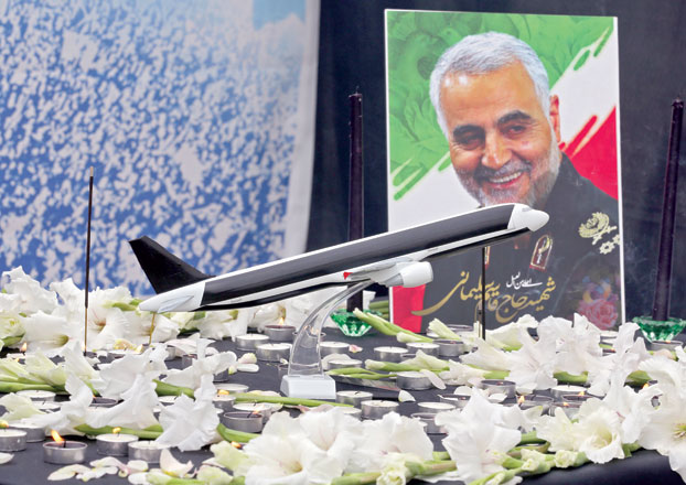A poster of slain military commander Qassem Soleimani is seen at a memorial for the victims of the Ukrainian plane crash, in University of Tehran, on Tuesday (AFP photo)