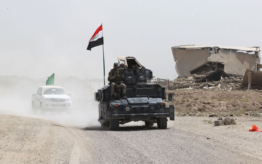 Iraqi government forces drive on a road near the village of Al Azraqiyah, northwest of the city of Fallujah, on Sunday, during an operation to regain control of the area from the Daesh terror group (AFP photo)