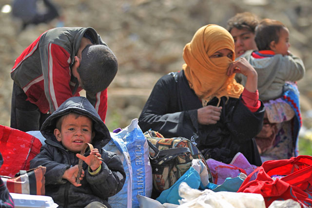 Iraqis displaced from the city of Mosul rest following their arrival at a camp in the Hamam Al Alil area south of the embattled city on Saturday, during the government forces ongoing offensive to retake the area from the Daesh group (AFP photo)