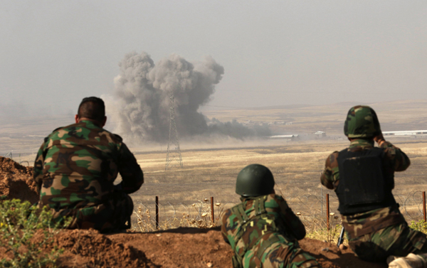 Smoke billows on the frontline as Iraqi Kurdish peshmerga forces hold a position near Hasan Sham village, some 45 kilometres east of the city of Mosul, during an operation aimed at retaking areas from the Daesh terror group on Sunday (AFP photo)