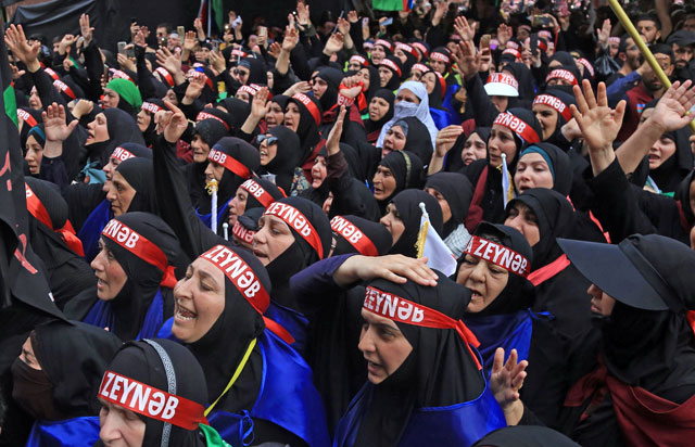 Shiite Muslim pilgrims mourn outside the Shrine of Imam Hussein in the holy Iraqi city of Karbala, 100 kilometres  south of Baghdad, on Saturday (AFP photo)