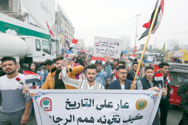Iraqi protesters march during an anti-government protest in Tahrir Square in the capital Baghdad on Sunday (AFP photo)