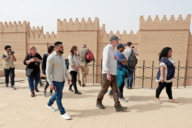 Foreign tourists visit the ancient city of Babylon, some 100km south of the Iraqi capital Baghdad, on March 7, 2022 (AFP photo)