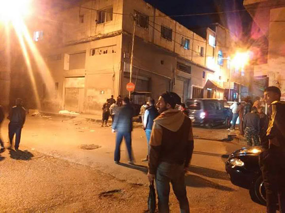 A photo posted on Irbid City Facebook page Tuesday night shows residents near the residential building the armed group holed up in