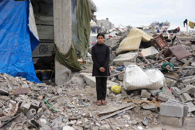 Maram Al-Assali, 12, poses in front of her destroyed home in Jabalia, northern Gaza Strip, on February 9, 2025 (AFP photo)