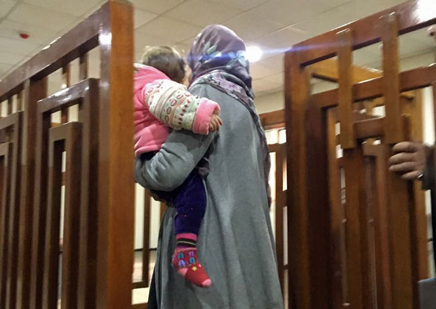 This file photo taken on February 19 shows French extremist Melina Boughedir carriyng her son, arriving at court in the Iraqi capital Baghdad (AFP photo)