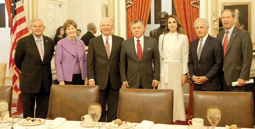 Their Majesties King Abdullah and Queen Rania pose for a group photo with US lawmakers in Washington on Wednesday (Photo courtesy of Royal Court)