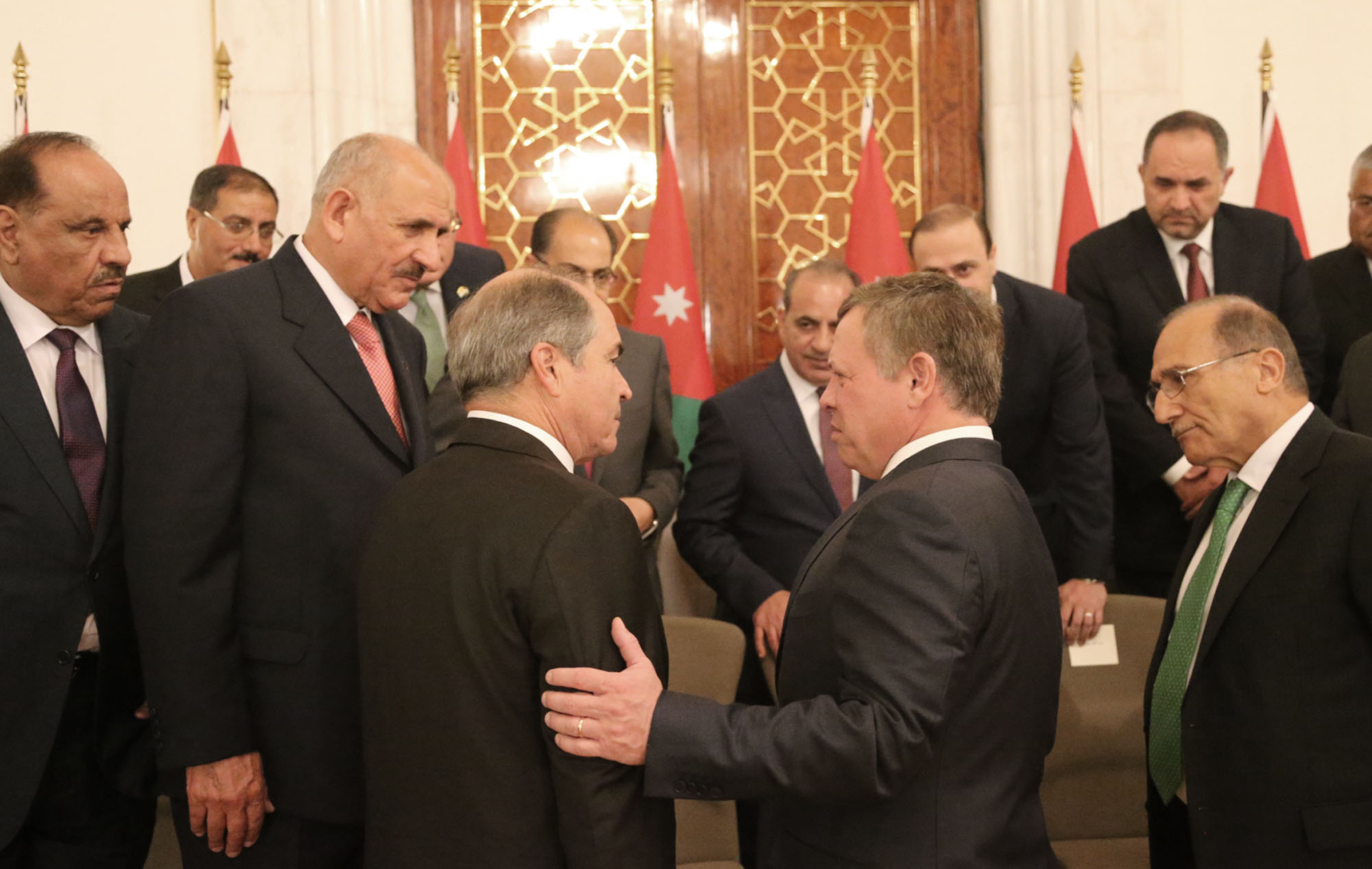 His Majesty King Abdullah speaks to Prime Minister Hani Mulki and members of his Cabinet during the swearing in ceremony on Wednesday (Photo courtesy of Royal Court)