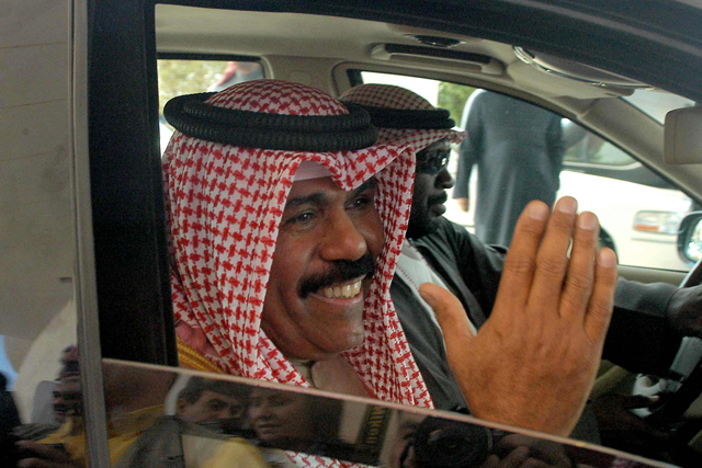 Kuwait's Crown Prince Sheikh Nawaf Al Ahmad Al Sabah leaves after taking the oath at the national assembly in Kuwait City on February 20, 2006.  (AFP photo)