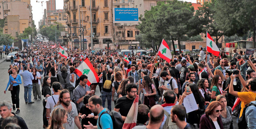 Lebanese protesters march during ongoing anti-government demonstrations in Lebanon's capital Beirut on Thursday (AFP photo)