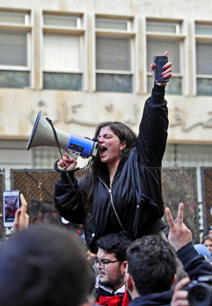 A Lebanese protester shouts slogans during a protest in front of the central bank headquarters in the capital Beirut to protest against the economic policies of the bank on Monday (AFP photo)