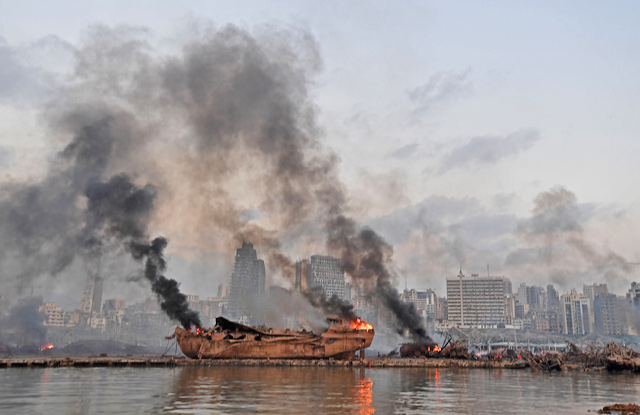 A ship in flames is photographed at the port of Beirut following a massive explosion that hit the heart of the Lebanese capital on Wednesday (AFP photo)