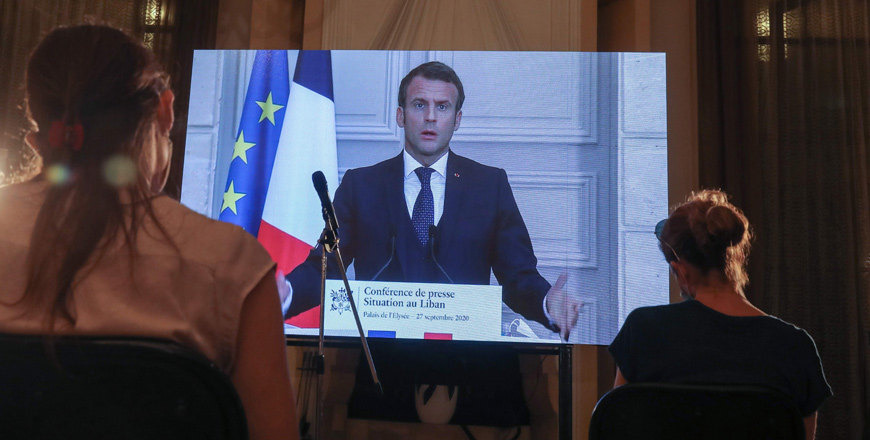 French President Emmanuel Macron addresses Lebanese journalists during a virtual press conference broadcast at the Pine Residence, the official residence of the French ambassador, in the capital Beirut on Sunday (AFP photo)
