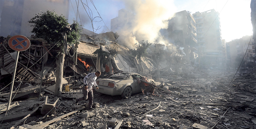 A man walks amid the rubble of a building hit in an overnight Israeli airstrike that targeted the neighbourhood of Moawwad in Beirut's southern suburbs on Thursday (AFP photo)