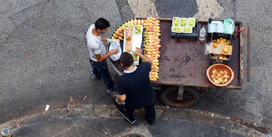 A Lebanese man buys prickly pears from a street vendor in the capital Beirut, on August 29 (AFP photo)