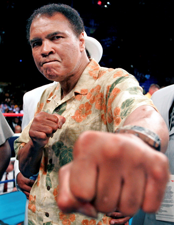 Boxing great Muhammad Ali shows his fists as he stands in the ring following his daughter Laila’s fight in Washington in this June 11, 2005 file photo (Reuters photo by Gary Hershorn)