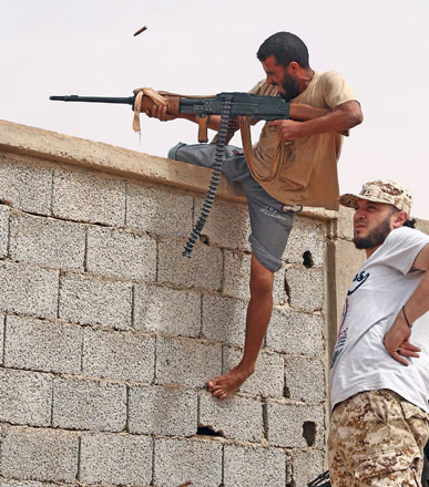 Forces loyal to Libya's UN-backed unity government are seen during clashes with militants of the Daesh terror group on the western outskirts of Sirte on Thursday (AFP photo)