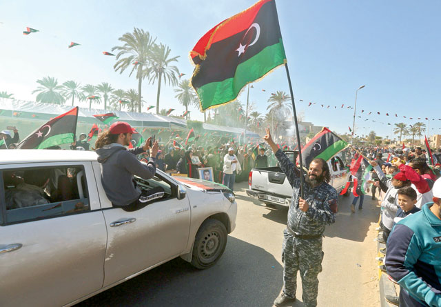 Libyans celebrate in Tripoli's landmark Martyrs Square on Tuesday the upcoming ninth anniversary of the Libyan revolution which toppled leader Muammar Qadhafi (AFP photo)