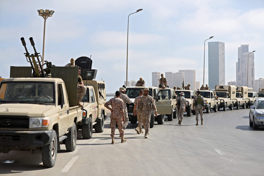 Vehicles of forces loyal to Libya's Tripoli-based Prime Minister Abdulhamid Dbeibah are parked along the waterfront (with the 'That El Emad Towers' complex seen in the background) in the capital Tripoli on Tuesday (AFP photo)