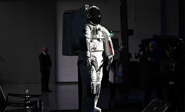 The AxEMU suit is photographed during a press conference of Prada and Axiom Space, as part of the presentation of the Axiom Extravehicular Mobility Unit designed and developed for the Artemis 3 lunar mission in collaboration with Prada, at the MiCo Convention Centre in Milan, northern Italy, on Wednesday (AFP photo)