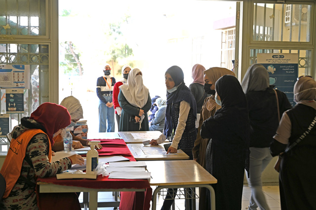 A woman registers to vote at a polling station in Amman on Tuesday (Photo by Amjad Ghsoun)
