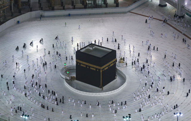 Saudis and foreign residents circumambulate (Tawaf) the Kaaba in the Grand Mosque complex in the holy city of Mecca, on Saturday, as authorities partially resume the year-round umrah for a limited number of pilgrims amid extensive health precautions after a seven-month coronavirus hiatus (AFP photo)